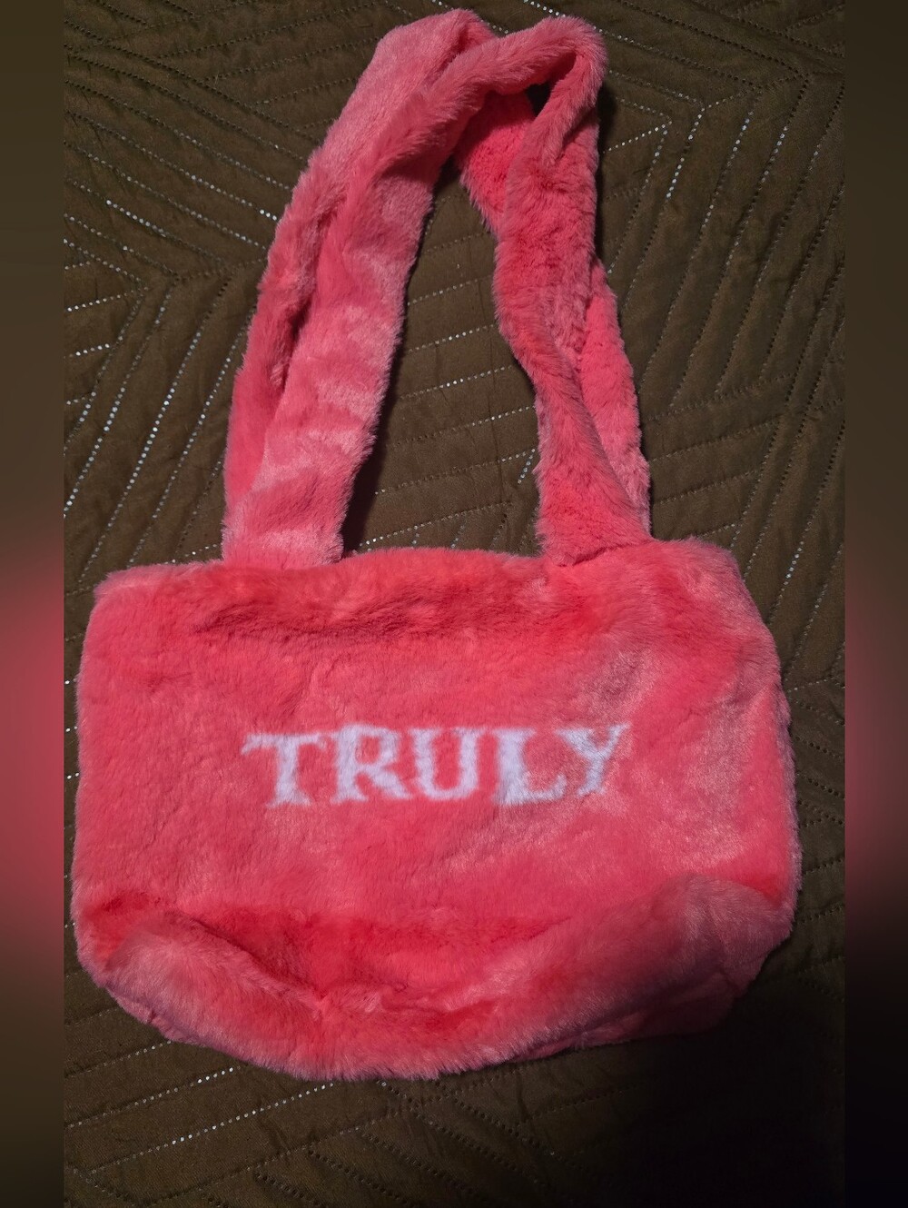 TRULY Beauty pink fuzzy handbag with a magnetic closure and branded interi